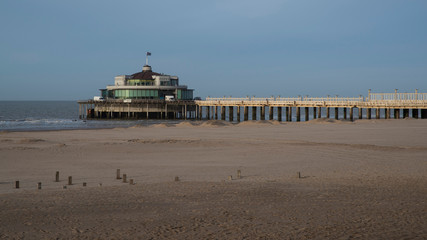 Round building at the end of the pier on a Belgian beach