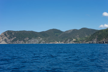 Italy,Cinque Terre,Riomaggiore, a large body of water with a mountain in the background