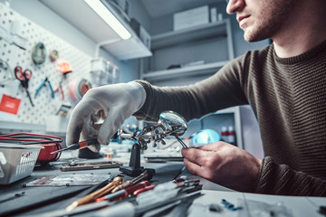 Electronic technician working in the modern repair shop