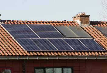 SSolar panels on a red roof for electric power generation