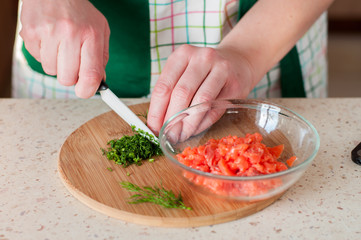 A Woman Chopping Dill, Salmon in a Bowl