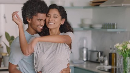 happy young couple dancing at home enjoying funny dance having fun celebrating