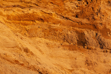bright orange surface of the soil with sand, background, texture