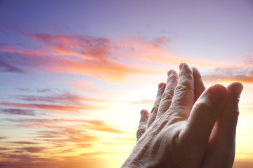 Prayer hands in sky
