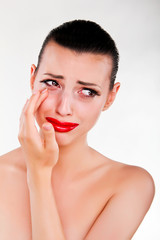 Close-up of young woman with problems crying