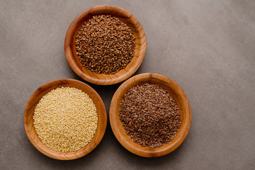 Collection of different groats, buckwheat, flax, in bowls. Set of Groats and Grains.