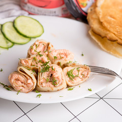 pancake rolls with filling on a serving plate