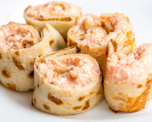 pancake rolls with filling on a serving plate