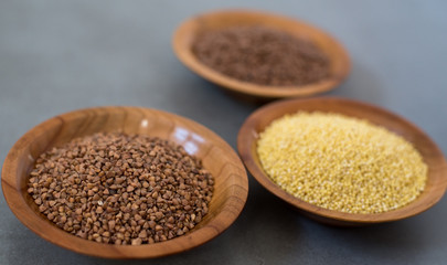 Collection of different groats, buckwheat, flax, in bowls. Set of Groats and Grains.