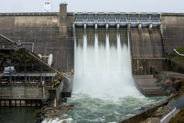 Folsom Lake dam with overflow water from flooding.