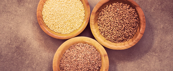 Collection of different groats, buckwheat, flax, in bowls. Set of Groats and Grains.