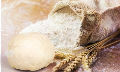 Wheat ears and flour on  background