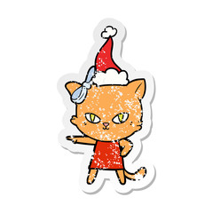 cute distressed sticker cartoon of a cat wearing dress wearing santa hat