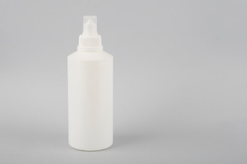 White bottle on a white background. Round white glossy plastic bottle for medical or cosmetic fluid, eye drops, oil. Realistic packaging mockup template. Side view