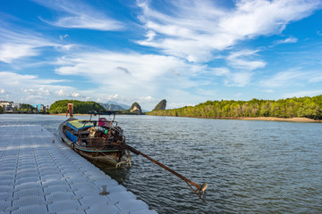 Obraz premium Empty moored long tail thai motor boat in Krabi Town in Khao Khanab Nam river water