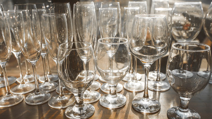 Empty clean glasses on the shelf in the restaurant. 