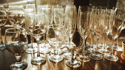 Empty clean glasses on the shelf in the restaurant. 