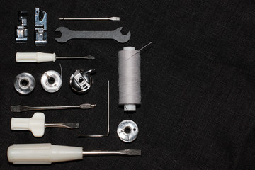 tools and accessories for sewing on a background of linen fabric