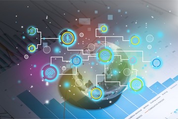 Glass globe ball in light rays on background of business charts