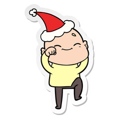 Fototapeta premium happy sticker cartoon of a bald man wearing santa hat