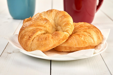 croissants and coffee cup on a wooden table