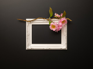 white frame on black background with cherry blossoms