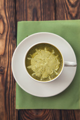 cup of hot matcha green tea latte on background