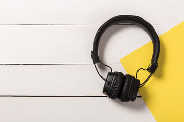 Headphones on white wooden background