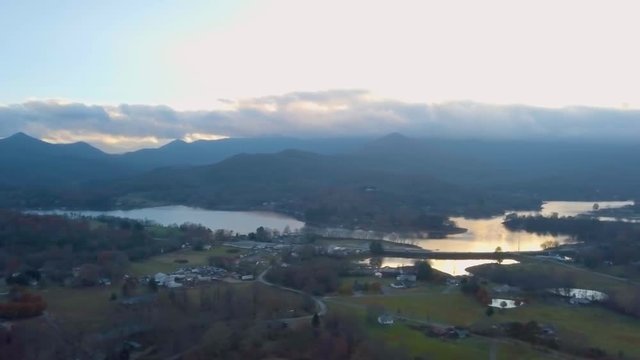207 Aerial panning revealing mountain houses and lake Autumn
