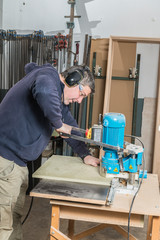 Male carpenter working in his carpentry workshop.