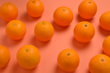 Group of oranges in a row on orange background, Space for text or design.
