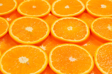 Slices of oranges as a background, top view.