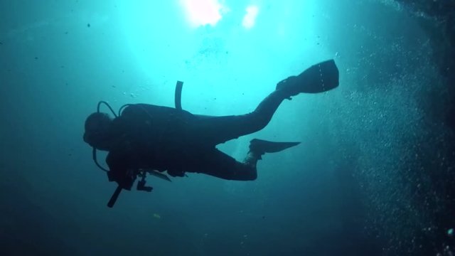 Scuba divers in the Zapotec or Hell's Bells cenote in Mexico.