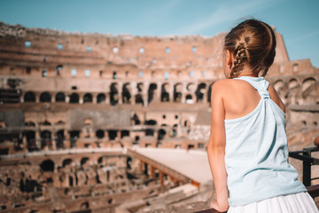 Fototapeta na wymiar Happy toddler girl in Rome over Coliseum background