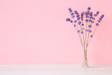 Dried, purple lavender in vase at pink wall. Soft pastel color. Mockup for positive idea. Empty place for inspirational, emotional, sentimental text, quote or sayings. Front view.  - obrazy, fototapety, plakaty
