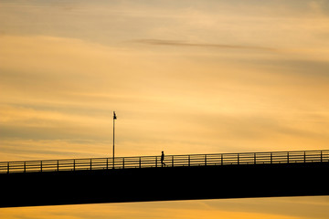 Obraz na płótnie Canvas man on bridge silhouette