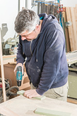 Male carpenter working in his carpentry workshop.