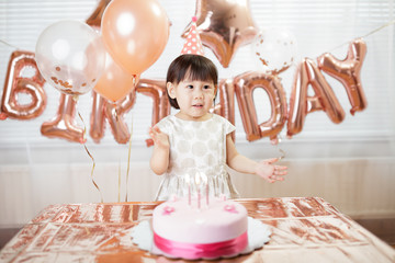 toddler girl celebrating her third birthday at home