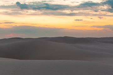Fototapeta na wymiar Untouched sand dunes at sunset - calmness and tranquility