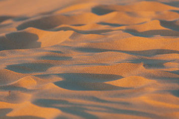 Fototapeta na wymiar Beach sand closeup at sunset