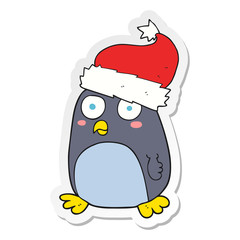 sticker of a cartoon penguin in christmas hat