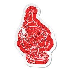 happy cartoon distressed sticker of a elf girl wearing santa hat