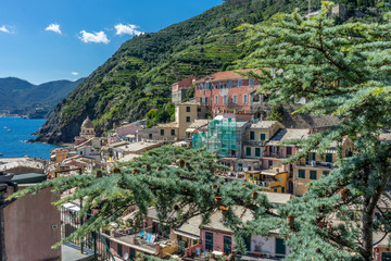 Italy, Cinque Terre, Vernazza, a building with a mountain in the background