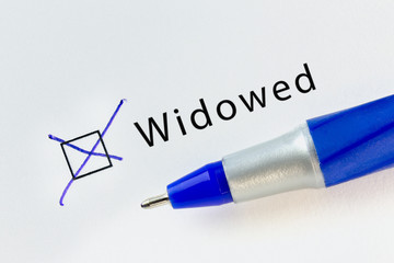 Widowed - checkbox with a cross on white paper with blue pen. Checklist concept