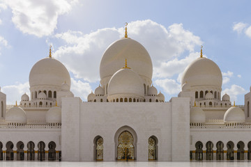 View of the front entrance of the inner courtyard of the white mosque of Abu Dhabi