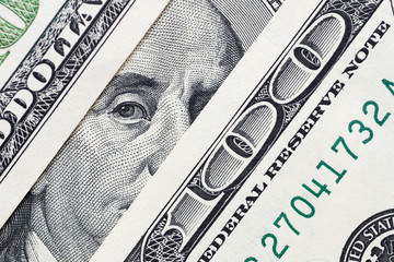 Benjamin Franklin's eyes from a hundred-dollar bill. The face of Benjamin Franklin on the hundred...