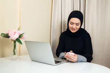 Arab happy casual woman using a smart phone at home