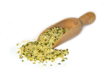Closeup of hulled hemp seeds, a plant based source of omega-3 fatty acids, presented on a small...