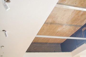 Electric sockets light works mounting and installation on plaster wall background. Professional installation of electrical outlets, wires and switches. Close up side view.