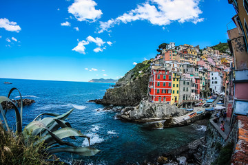 Fototapeta na wymiar View of the beautiful seaside of Riomaggiore village in summer in the Cinque Terre area, Italy